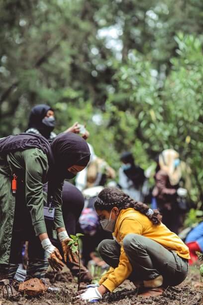 mother daughter planting tree